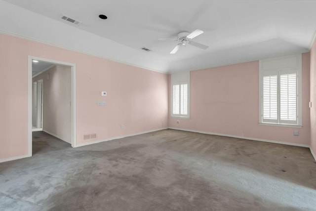 carpeted empty room featuring ceiling fan, visible vents, and baseboards