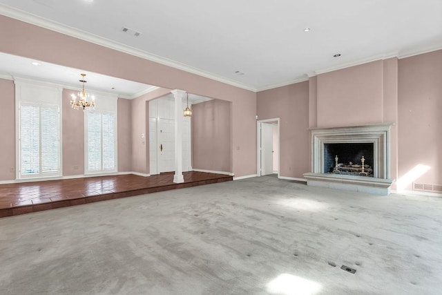 unfurnished living room featuring baseboards, a fireplace with raised hearth, crown molding, carpet floors, and a notable chandelier