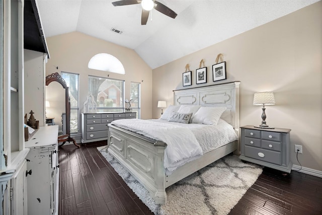 bedroom featuring dark wood-style floors, ceiling fan, lofted ceiling, and visible vents