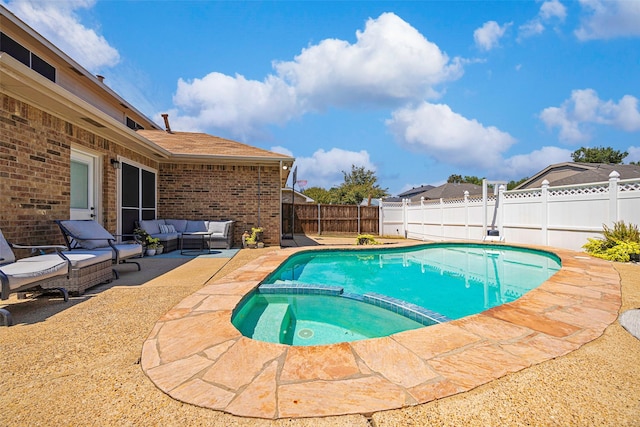 view of pool with outdoor lounge area, a patio area, a fenced backyard, and a pool with connected hot tub