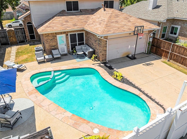 view of pool with a patio area, a fenced backyard, a gate, and a pool with connected hot tub