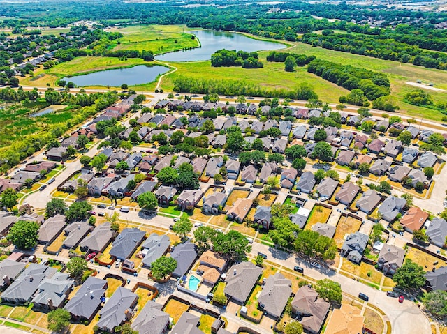 drone / aerial view featuring a residential view and a water view