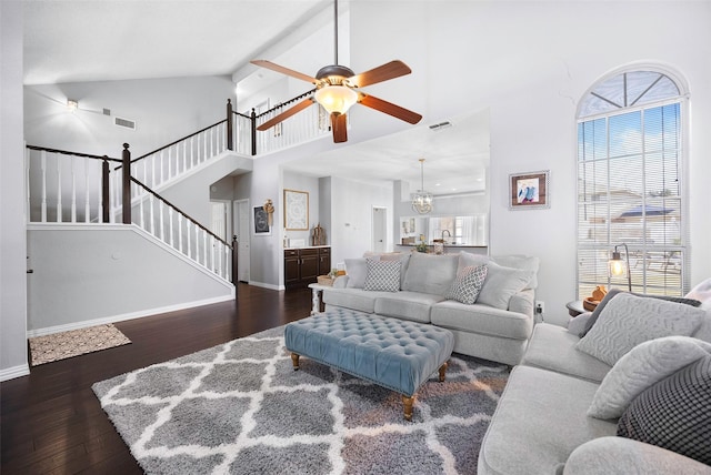 living area featuring visible vents, stairway, high vaulted ceiling, baseboards, and hardwood / wood-style flooring