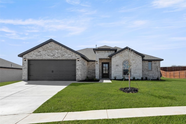 french provincial home with brick siding, an attached garage, a front lawn, fence, and driveway