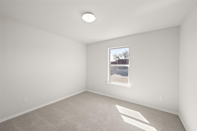 unfurnished room featuring baseboards and carpet floors