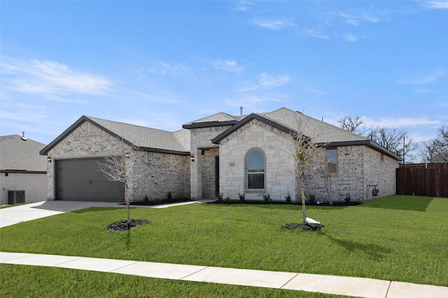 french country inspired facade featuring a front lawn, an attached garage, driveway, and fence