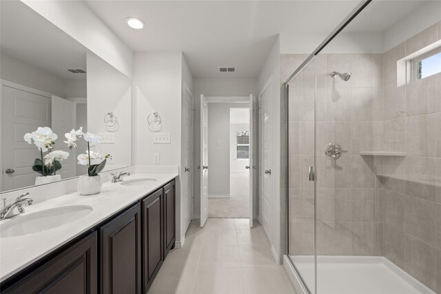 full bathroom featuring visible vents, a shower stall, and a sink