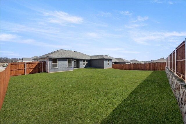 view of yard with a fenced backyard