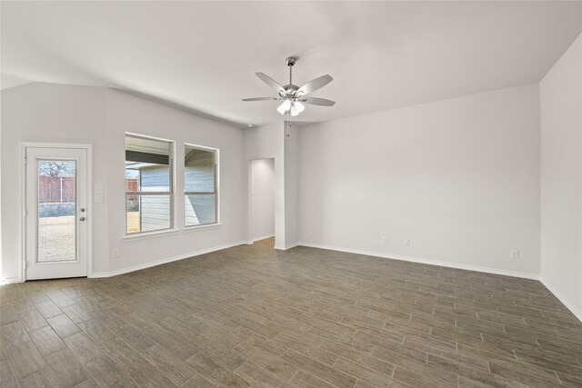 spare room featuring ceiling fan, baseboards, lofted ceiling, and dark wood-style floors