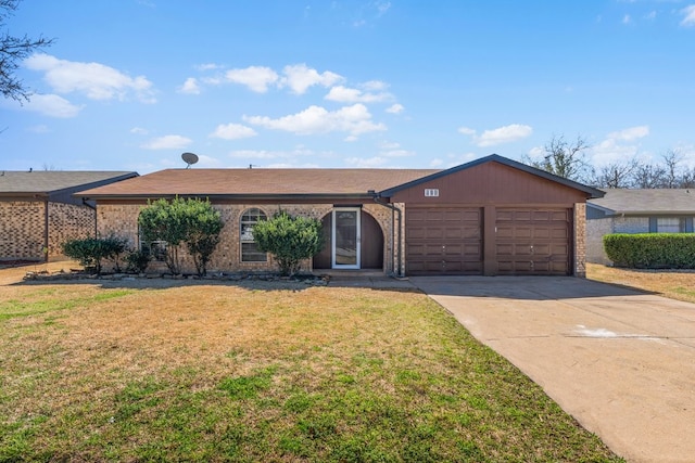 ranch-style house featuring an attached garage, a front lawn, concrete driveway, and brick siding