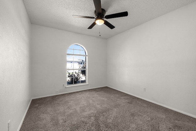 carpeted empty room featuring a textured wall, ceiling fan, a textured ceiling, and baseboards