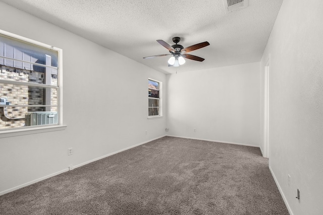 empty room featuring baseboards, visible vents, ceiling fan, a textured ceiling, and carpet flooring