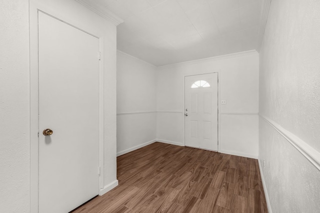 entrance foyer featuring baseboards, ornamental molding, and wood finished floors