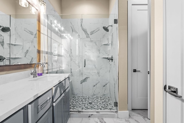 bathroom with marble finish floor, a marble finish shower, and vanity