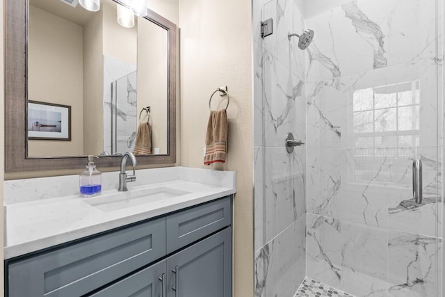 full bathroom featuring vanity and a marble finish shower