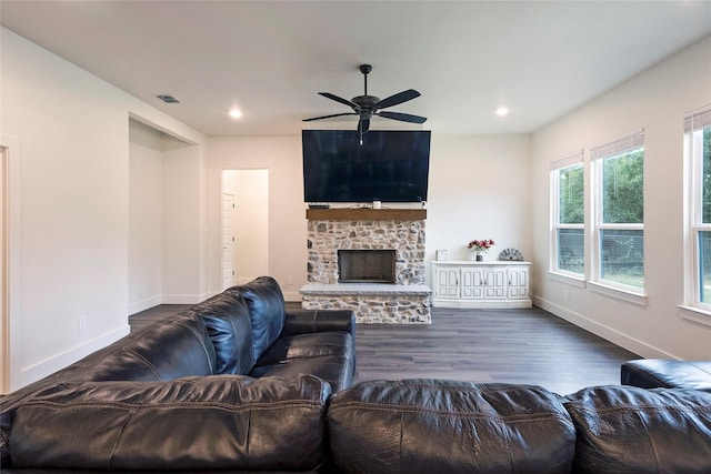 living room with recessed lighting, a stone fireplace, baseboards, and wood finished floors