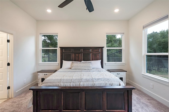 bedroom featuring baseboards, recessed lighting, and light colored carpet