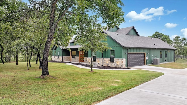 317 Zion Forest Trl, Poolville, TX 76487 - view of front of property featuring an attached garage, driveway, board and batten siding, stone siding, and a front lawn