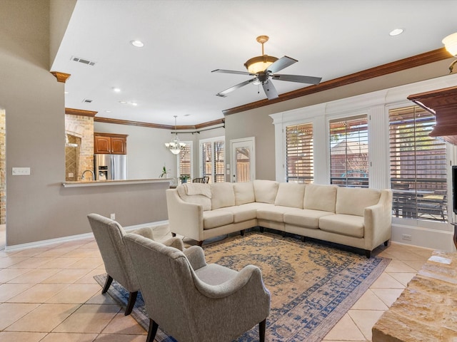 living room with a wealth of natural light, crown molding, baseboards, and light tile patterned floors