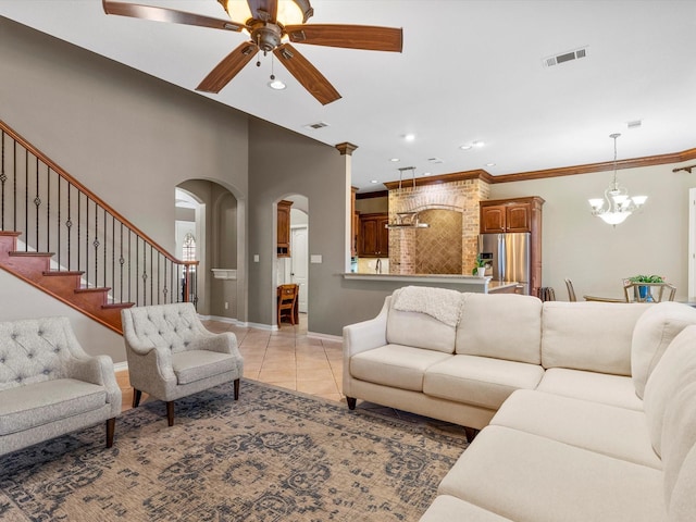 living area featuring stairs, visible vents, ornamental molding, and light tile patterned flooring