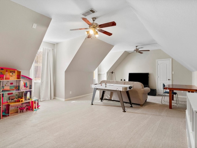 interior space with lofted ceiling, ceiling fan, visible vents, baseboards, and carpet