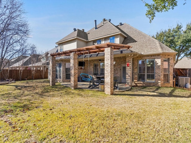 rear view of house with a patio, fence, a yard, a pergola, and brick siding