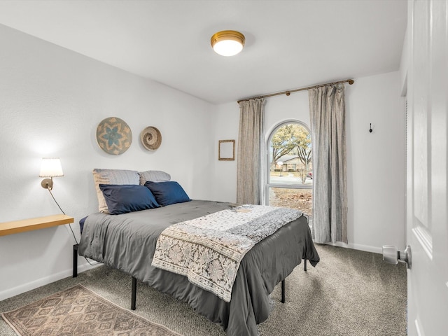 bedroom featuring carpet flooring and baseboards