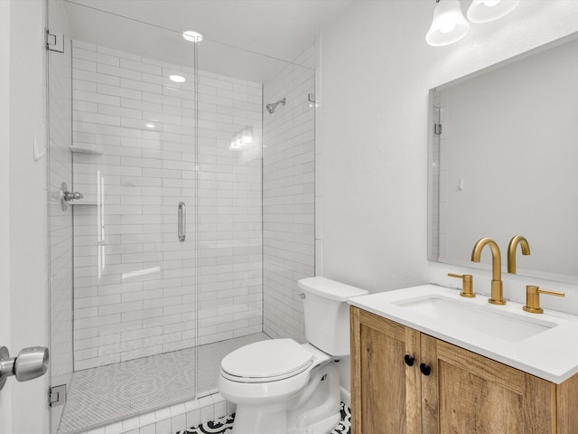 full bathroom featuring a stall shower, vanity, and toilet