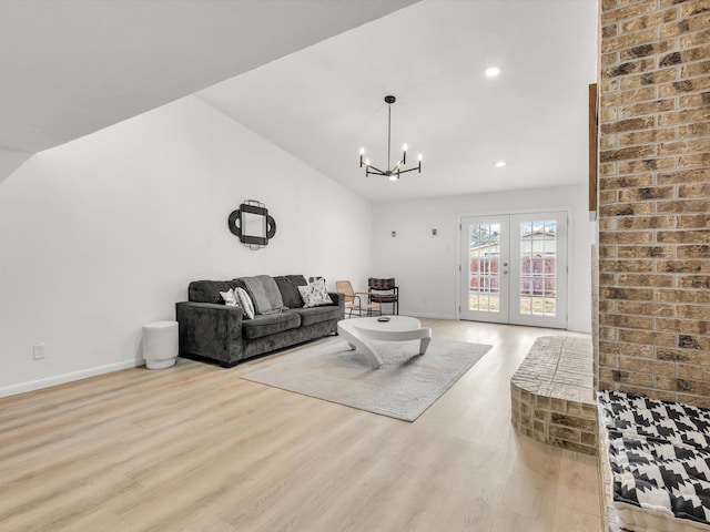 living room with baseboards, lofted ceiling, wood finished floors, french doors, and recessed lighting