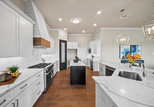 kitchen featuring a sink, appliances with stainless steel finishes, decorative backsplash, light stone countertops, and dark wood-style flooring