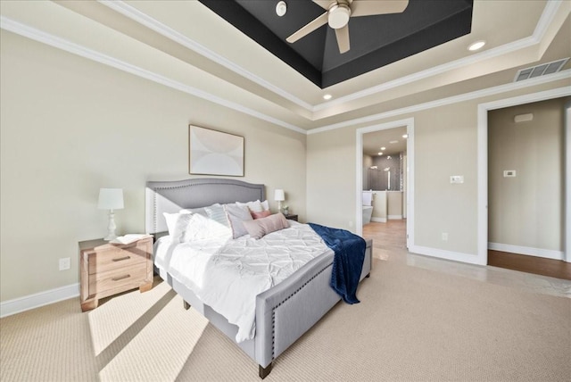 carpeted bedroom with visible vents, baseboards, crown molding, and a tray ceiling