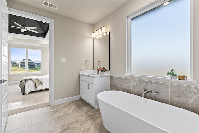 ensuite bathroom featuring visible vents, ceiling fan, a freestanding bath, ensuite bathroom, and vanity