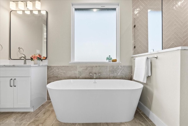 bathroom with vanity, a soaking tub, tile walls, and tiled shower