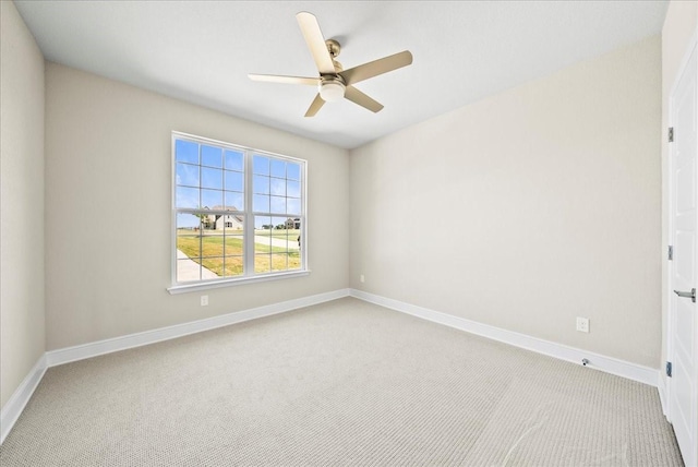 empty room with baseboards, carpet floors, and ceiling fan