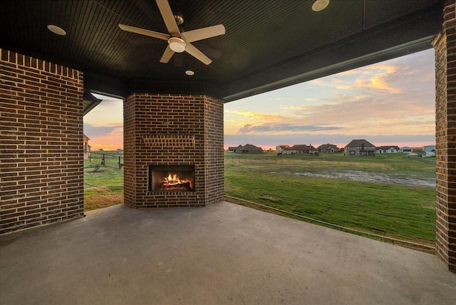 view of patio / terrace with ceiling fan and an outdoor brick fireplace