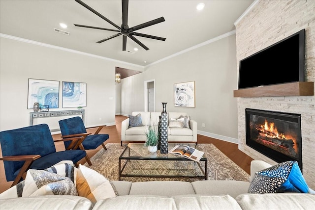 living room with visible vents, baseboards, ornamental molding, a fireplace, and wood finished floors