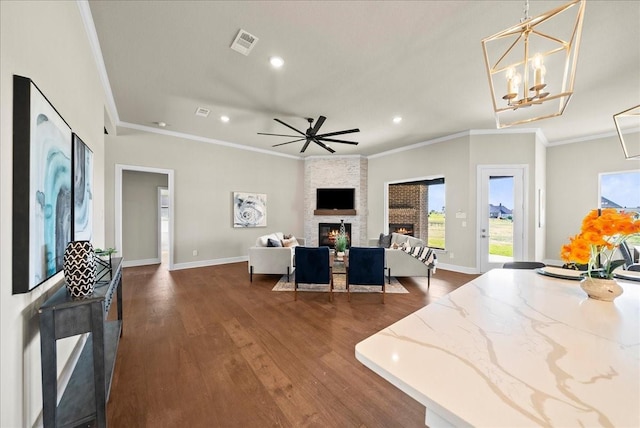 interior space featuring dark wood finished floors, a fireplace, visible vents, and a healthy amount of sunlight