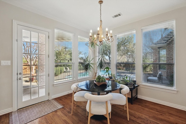 dining room featuring ornamental molding, visible vents, plenty of natural light, and wood finished floors