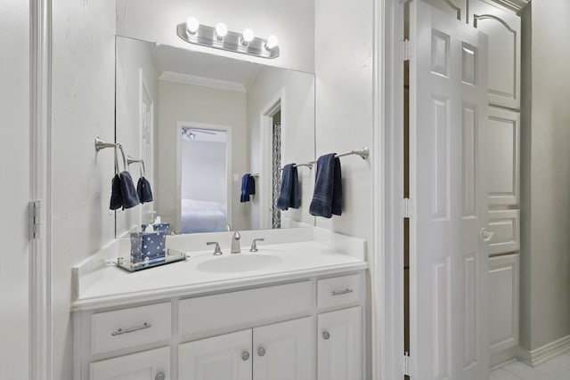 ensuite bathroom featuring ornamental molding, ensuite bath, and vanity