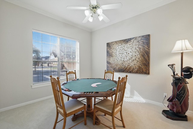 dining space with light carpet, baseboards, and crown molding