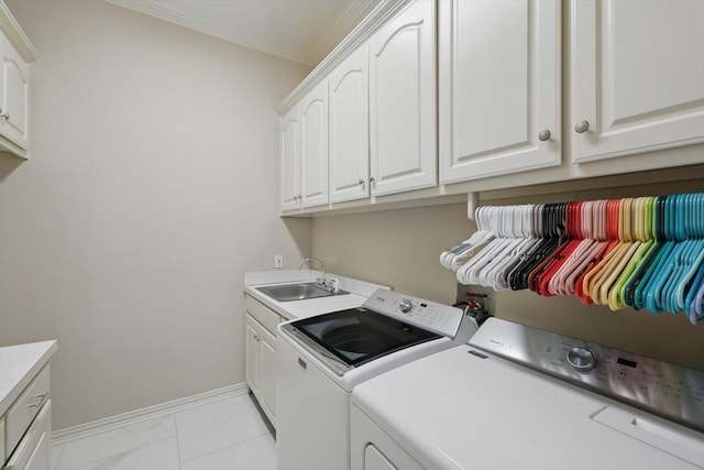 washroom with washer and clothes dryer, cabinet space, ornamental molding, a sink, and baseboards