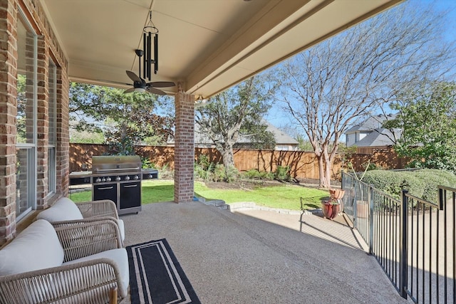 view of patio / terrace with a fenced backyard, a ceiling fan, and a grill