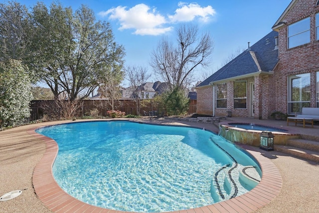 view of swimming pool featuring a pool with connected hot tub, a fenced backyard, and a patio