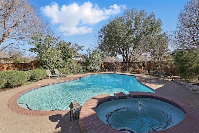 view of pool with a patio area, a fenced backyard, and a pool with connected hot tub