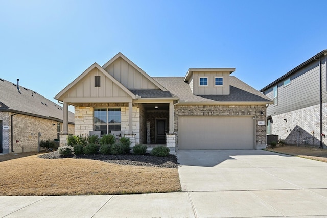 craftsman-style home featuring cooling unit, roof with shingles, board and batten siding, concrete driveway, and an attached garage