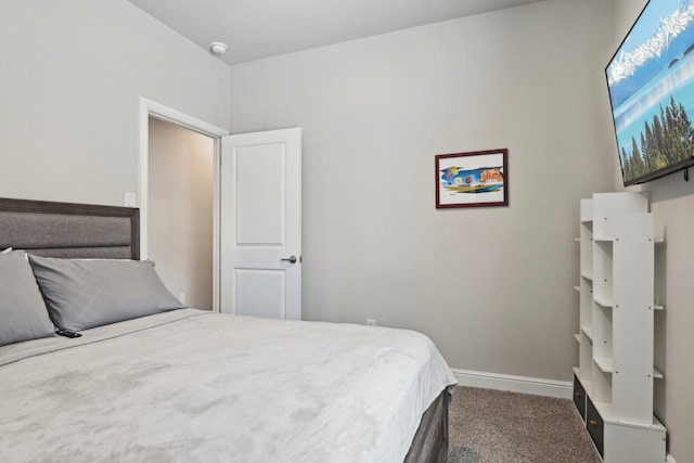 bedroom with carpet flooring and baseboards