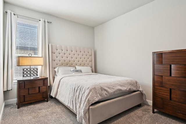 carpeted bedroom featuring baseboards