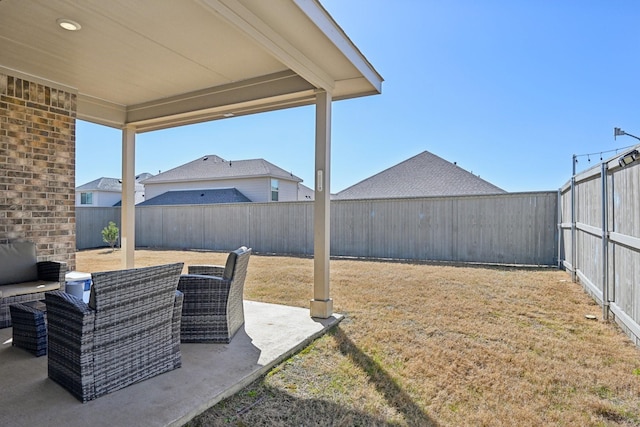 view of yard featuring a patio area, an outdoor living space, and a fenced backyard