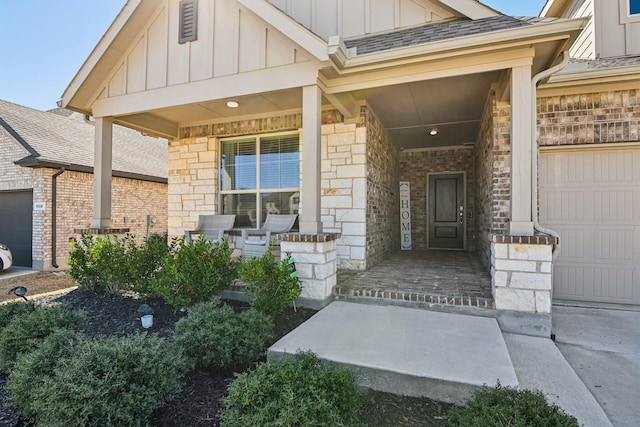 entrance to property with stone siding, a porch, roof with shingles, board and batten siding, and an attached garage