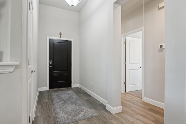 entrance foyer featuring wood finished floors and baseboards